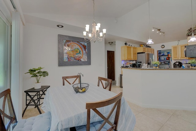 tiled dining room featuring an inviting chandelier and lofted ceiling