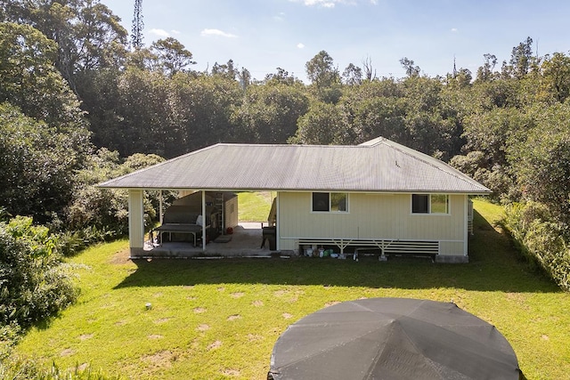 rear view of house with a lawn