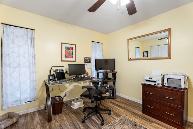 home office with light hardwood / wood-style floors and ceiling fan