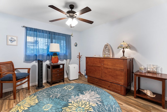 bedroom with light hardwood / wood-style flooring and ceiling fan