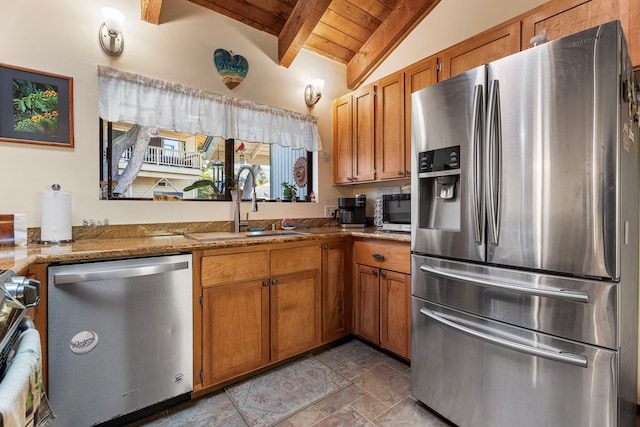 kitchen featuring sink, vaulted ceiling with beams, light stone countertops, wood ceiling, and stainless steel appliances