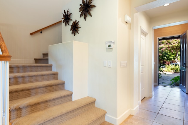 stairs featuring tile patterned flooring