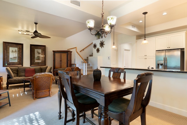 carpeted dining space featuring ceiling fan with notable chandelier