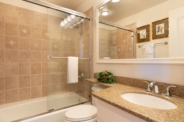 full bathroom with vanity, toilet, and shower / bath combination with glass door