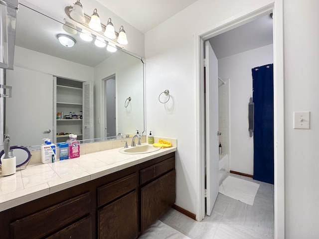 bathroom with vanity, shower / bath combination with curtain, and tile patterned flooring