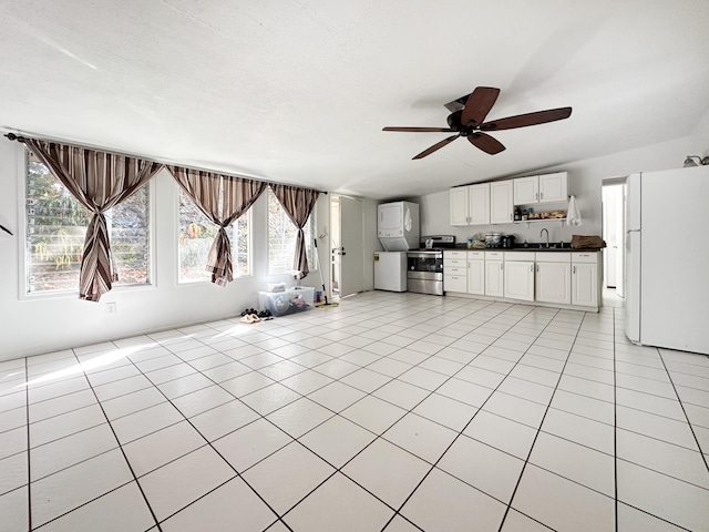 kitchen with ceiling fan, white cabinetry, stainless steel range with electric stovetop, light tile patterned flooring, and white fridge