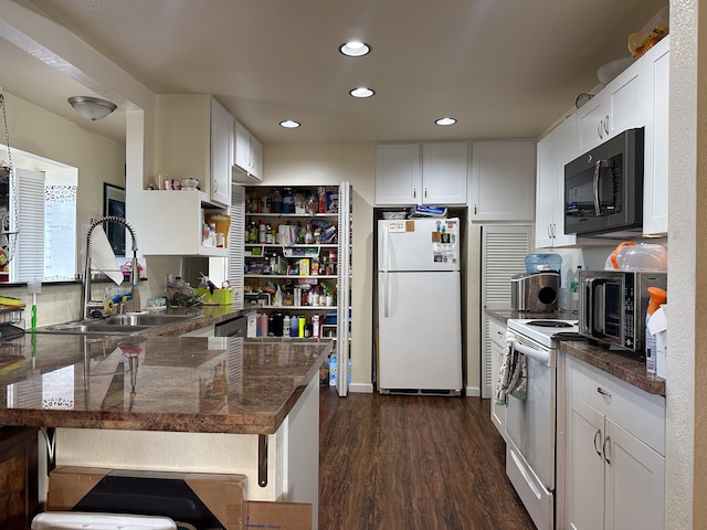 kitchen featuring sink, white cabinetry, white appliances, and kitchen peninsula