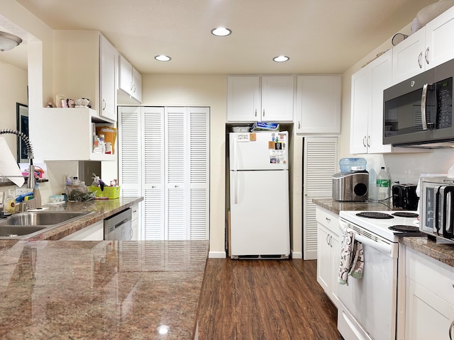 kitchen featuring white cabinets, appliances with stainless steel finishes, dark hardwood / wood-style flooring, and sink