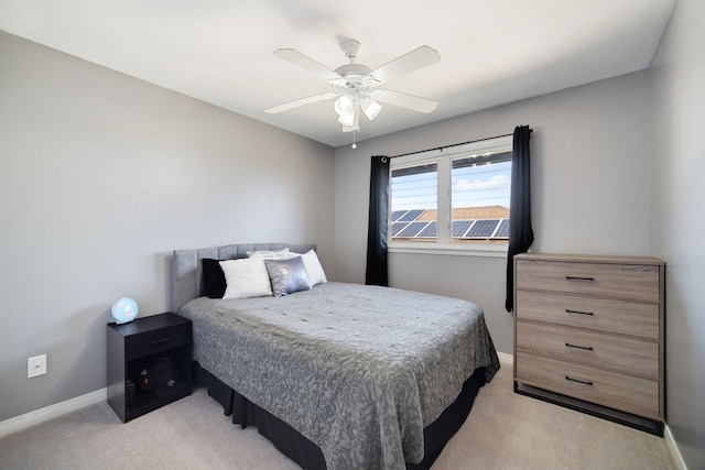 bedroom featuring light colored carpet and ceiling fan