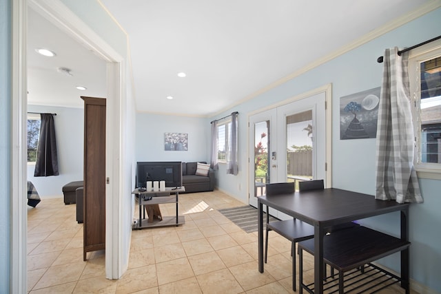 dining area with french doors, ornamental molding, and light tile patterned floors