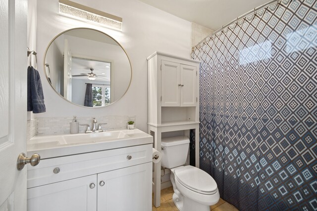 bathroom with a shower with curtain, vanity, toilet, and decorative backsplash