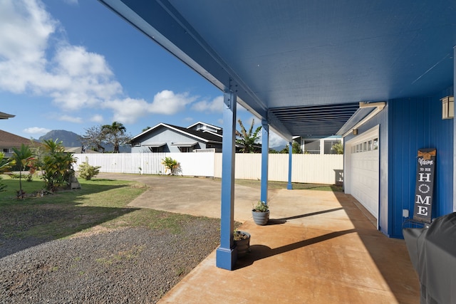 view of patio / terrace with a mountain view and a garage