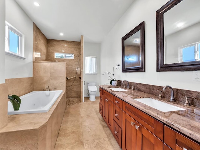 full bathroom with tile patterned flooring, a wealth of natural light, vanity, and toilet