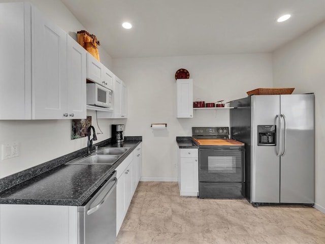 kitchen with stainless steel appliances, white cabinetry, and sink