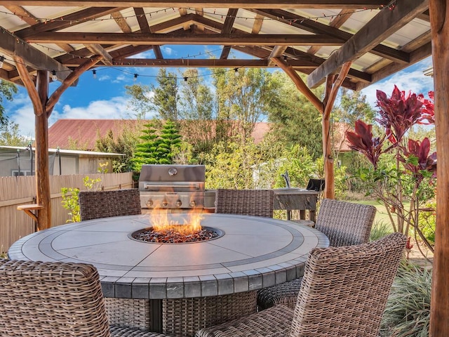 view of patio / terrace with a fire pit and grilling area