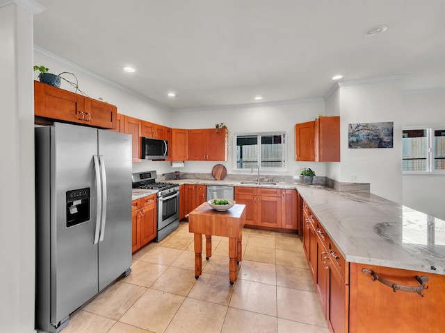 kitchen with light stone countertops, crown molding, kitchen peninsula, and appliances with stainless steel finishes