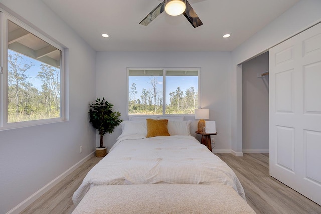 bedroom featuring a closet, light hardwood / wood-style flooring, and ceiling fan