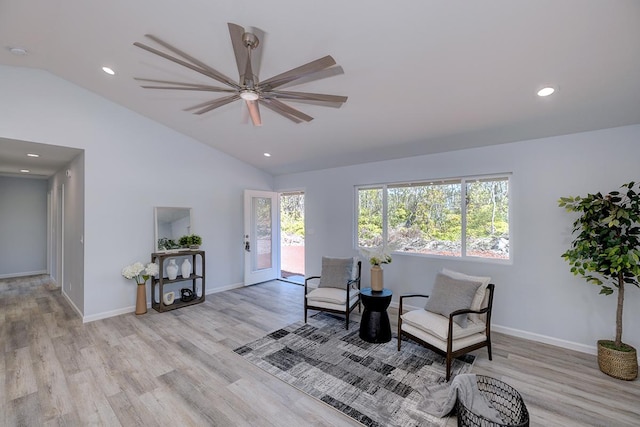 sitting room with light hardwood / wood-style floors, ceiling fan, and lofted ceiling