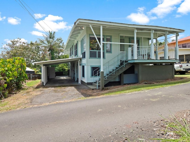 view of front of home with a carport and a porch