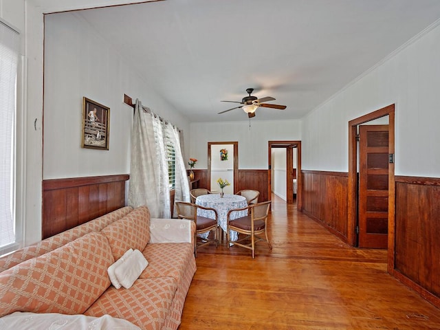 living room featuring light wood-type flooring and ceiling fan