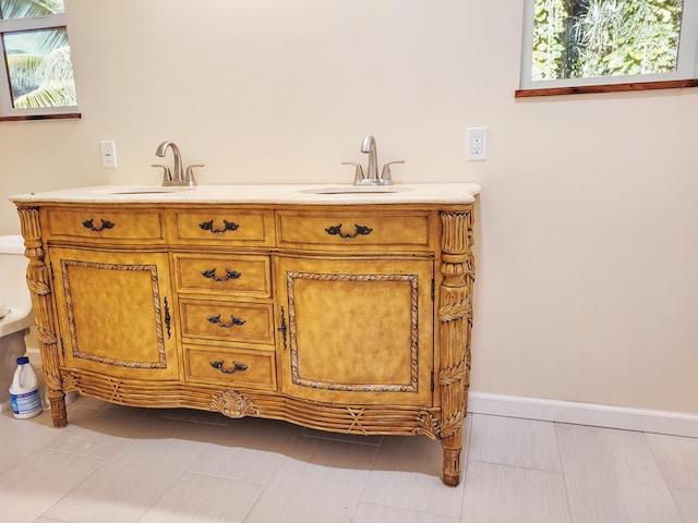 bathroom featuring tile patterned floors, vanity, and toilet