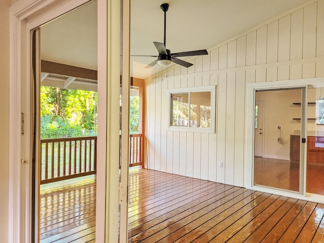 unfurnished sunroom with ceiling fan and lofted ceiling