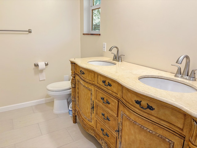 bathroom featuring tile patterned floors, vanity, and toilet