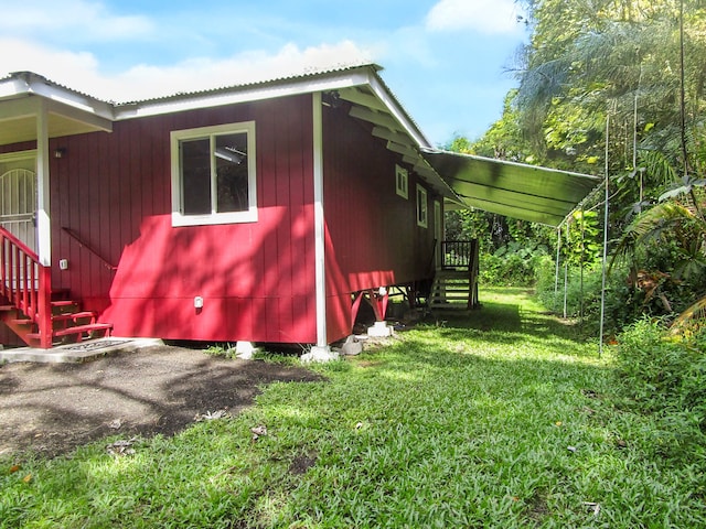 view of property exterior with a yard and a carport