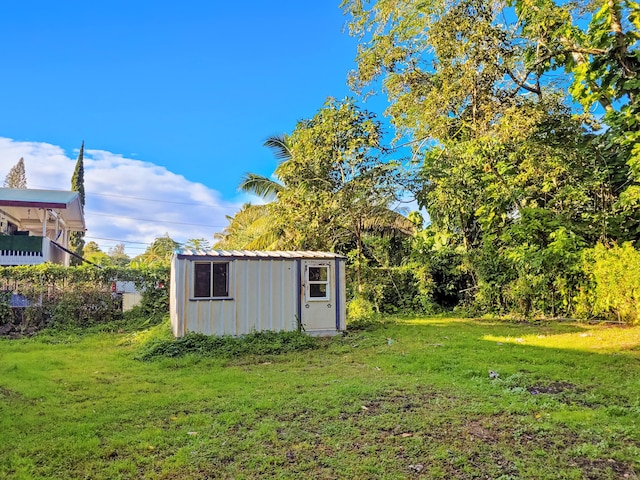 view of outbuilding with a yard