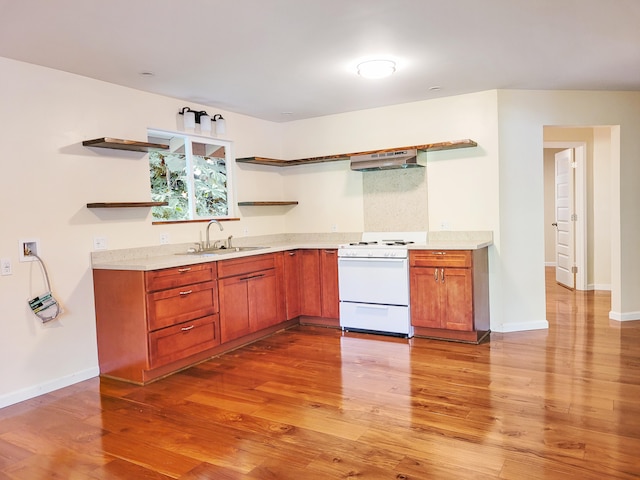 kitchen featuring white range oven, extractor fan, light hardwood / wood-style floors, and sink