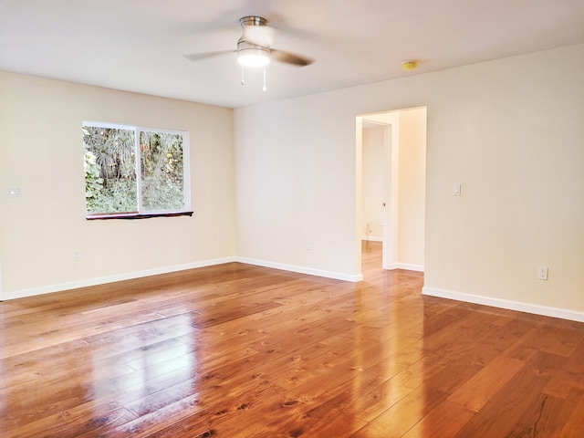 empty room with ceiling fan and hardwood / wood-style floors