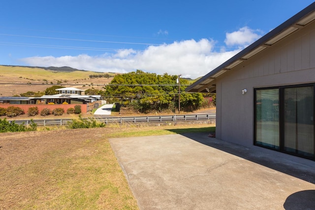 view of yard with a mountain view and a patio area