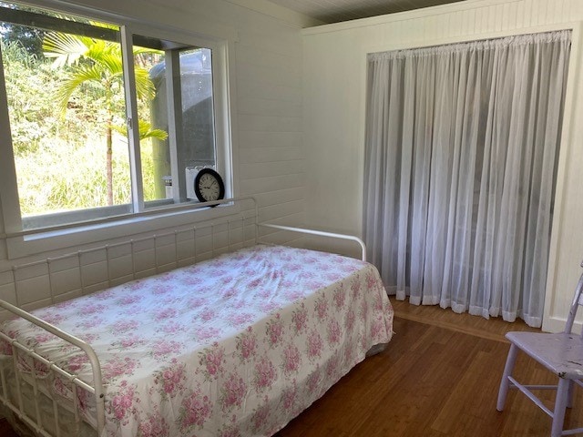 bedroom featuring dark hardwood / wood-style flooring