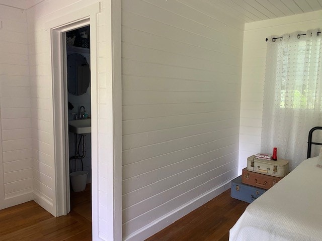 bedroom with dark wood-type flooring