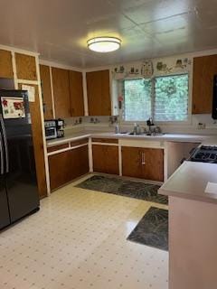 kitchen with black fridge and sink