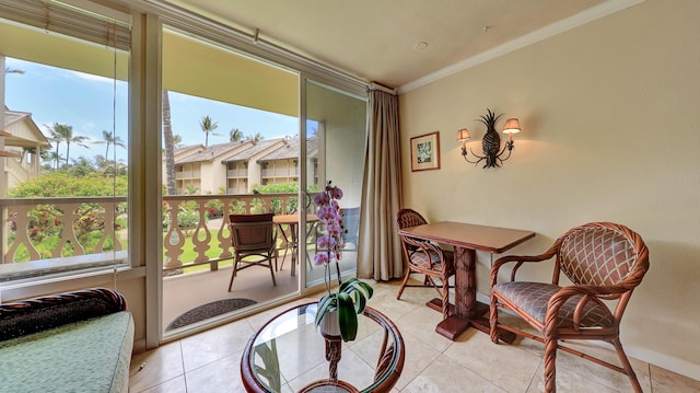 sitting room with crown molding and light tile patterned floors