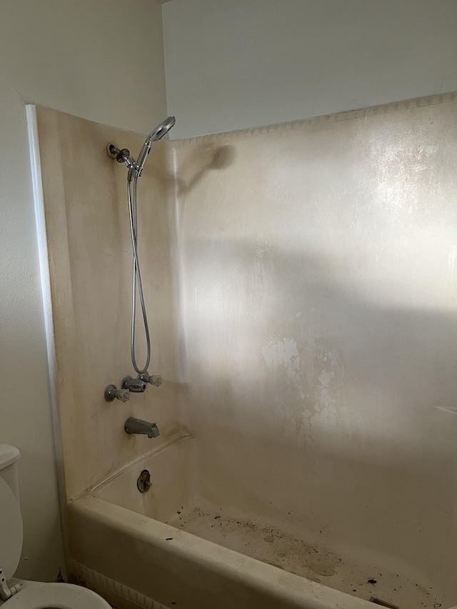 bathroom featuring toilet and shower / bathing tub combination