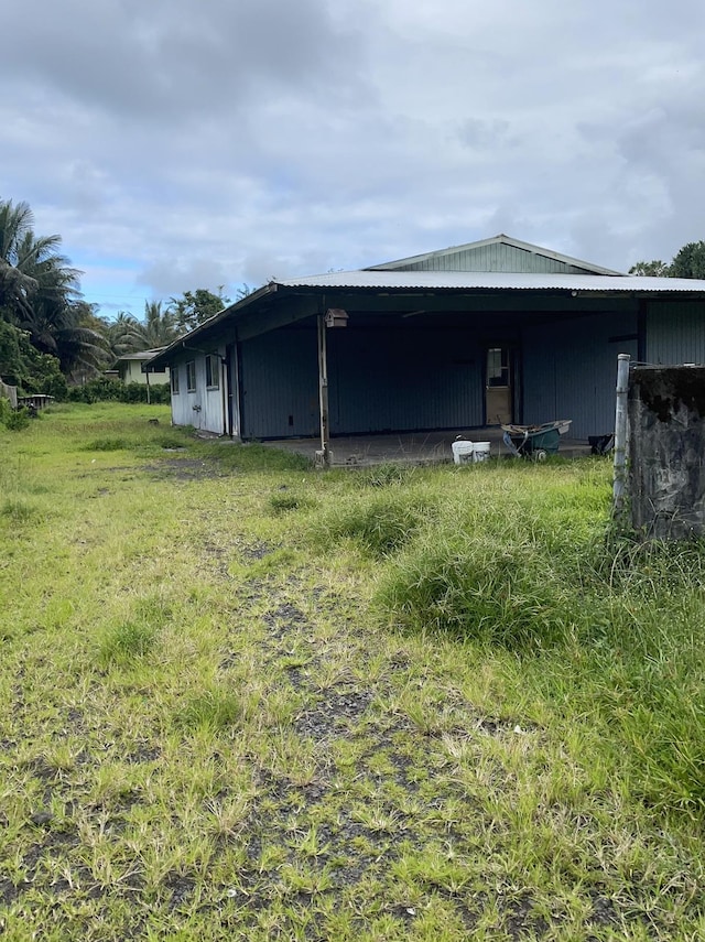 view of side of home with a lawn