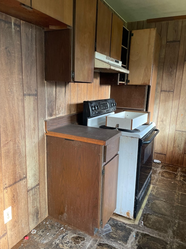 kitchen featuring wood walls and electric range oven