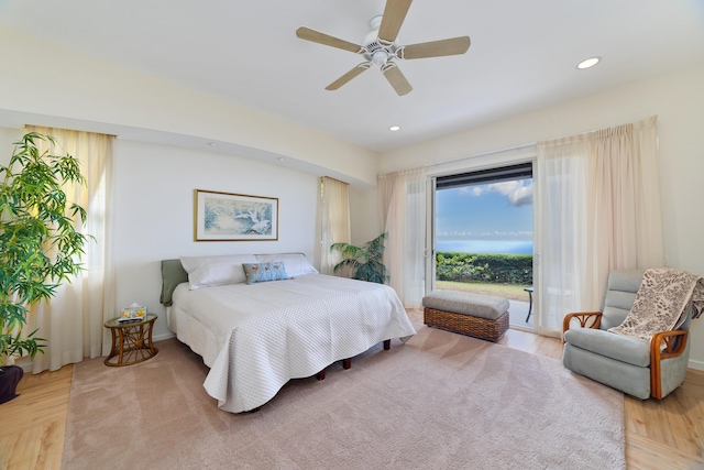 bedroom with ceiling fan, access to outside, and light hardwood / wood-style flooring