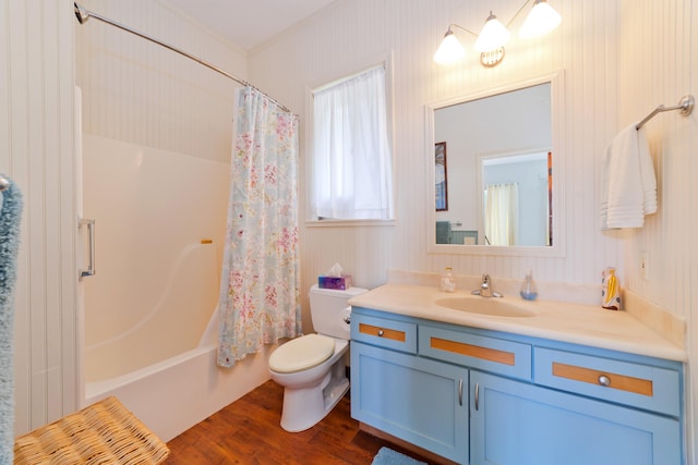 full bathroom featuring toilet, vanity, shower / tub combo, hardwood / wood-style flooring, and ornamental molding