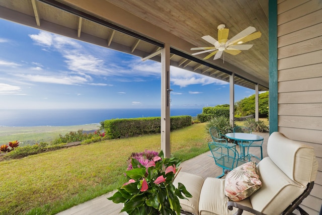 view of patio / terrace with ceiling fan and a water view