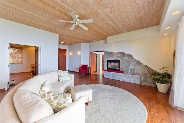 living room with ceiling fan, dark wood-type flooring, a fireplace, and wooden ceiling