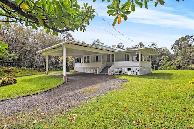 view of front of home with a front yard and a carport