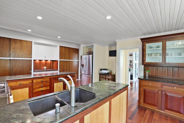 kitchen featuring sink, stainless steel fridge with ice dispenser, dark stone counters, light hardwood / wood-style floors, and wood ceiling