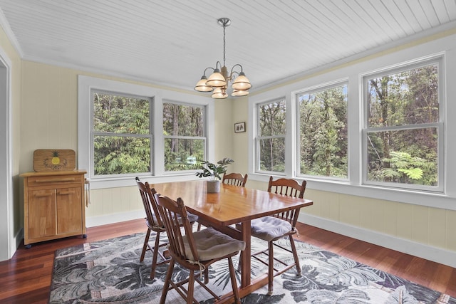 dining area featuring a chandelier, crown molding, plenty of natural light, and dark wood-type flooring