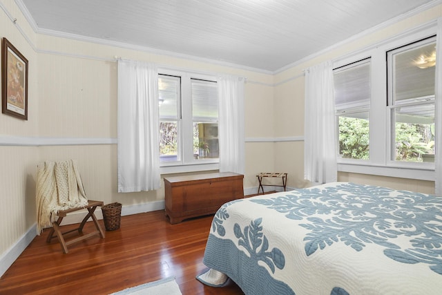 bedroom featuring multiple windows, dark hardwood / wood-style floors, and ornamental molding