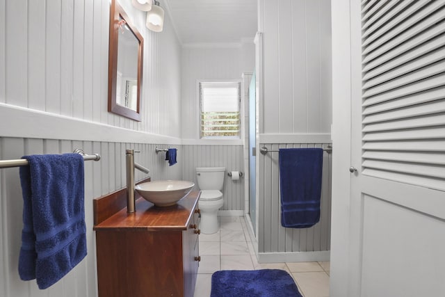 bathroom with tile patterned floors, toilet, vanity, and ornamental molding