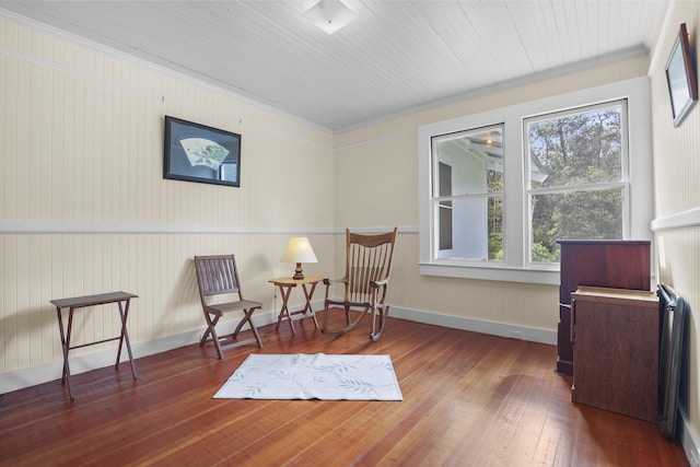 sitting room featuring dark hardwood / wood-style floors, a wealth of natural light, and ornamental molding