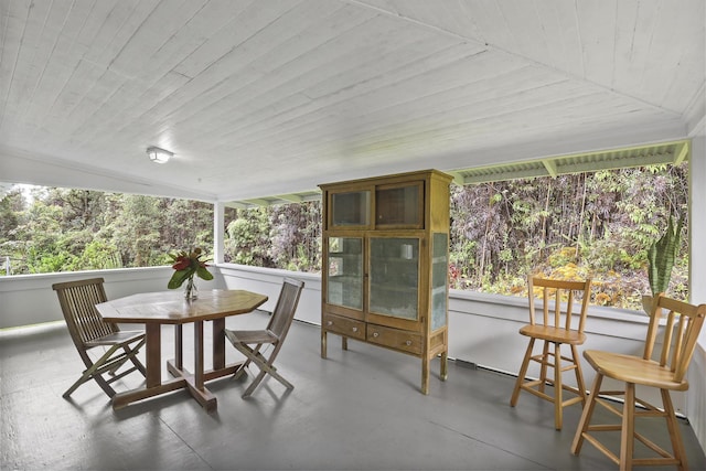 sunroom / solarium featuring wood ceiling and lofted ceiling